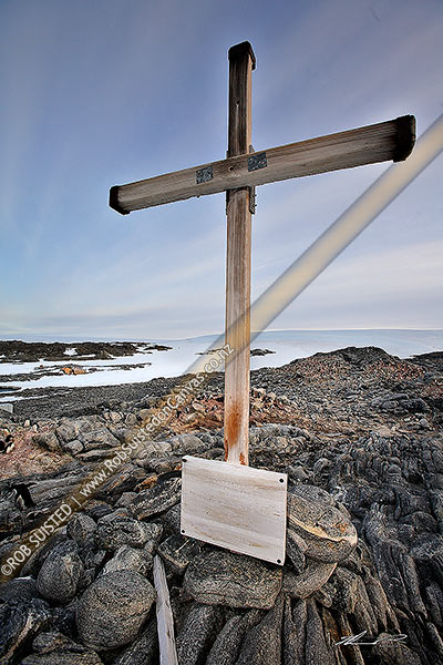 Photo of 1913 Memorial Cross for Belgrave Ninnis and Xavier Mertz, Azimuth Hill, Mawson's Huts behind, Cape Denison, Commonwealth Bay, Antarctica, Antarctica Region, Antarctica