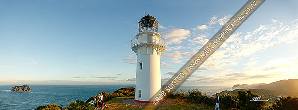 Photo of East Cape Lighthouse panorama at dusk with tourist visitors taking photograph. East Island (Whangoakeno) at left, East Cape, Gisborne, Gisborne Region, New Zealand (NZ)