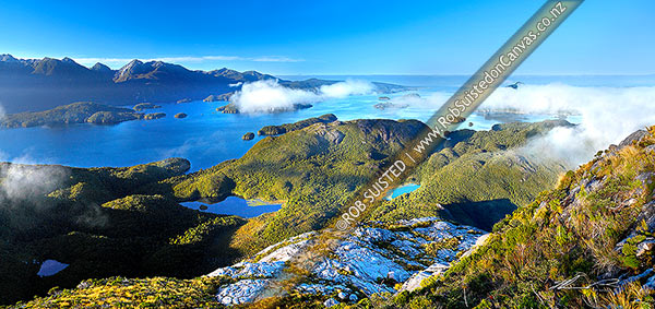Photo of Dusky Sound and Bowen Channel from Resolution Island (Maori: Tau Moana). Indian Is, Cook Channel and Cascade Cove left, Anchor Island right (in cloud). Panorama, Fiordland National Park, Southland, Southland Region, New Zealand (NZ)