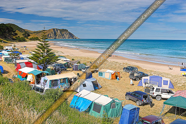 Photo of Summertime Christmas holiday campers tent camping at Waihau Bay Beach campground, Wainui Beach, Gisborne, Gisborne Region, New Zealand (NZ)