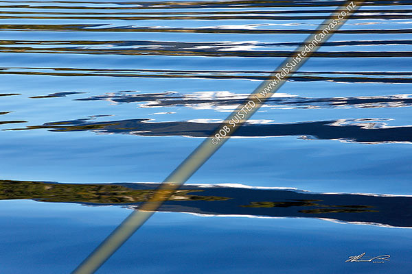 Photo of Ripples waves and patterns reflecting on sea water in Fiordland on a calm sunny day,, New Zealand (NZ)