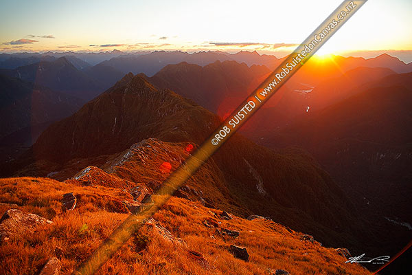 Photo of Dramatic sunset on the Edith - George River tops, looking SW to Lake Alice (left), George Sound (right) and Expedition Peak (1314m) far centre right. Wilderness area, Edith River, Fiordland National Park, Southland, Southland Region, New Zealand (NZ)