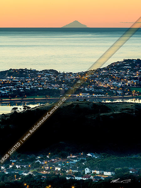 Photo of Porirua Harbour City, harbour and Titahi Bay, with Mt Taranaki on horizon across the Tasman Sea and South Taranaki Bight. Twilight panorama, Porirua, Porirua City, Wellington Region, New Zealand (NZ)