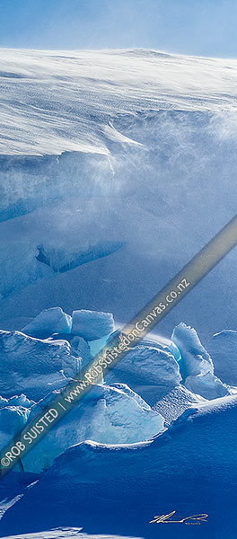 Photo of Catabatic blizzard winds blow spindrift, snow and ice particles over the ice sheet and and pressure ridges below. Vertical panorama, Ross Sea, Antarctica, Antarctica Region, Antarctica