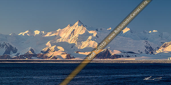 Photo of Mount (Mt) Herschel (3335m) standing in the Admiralty Mountains. First climbed in 1967 by Sir Ed Hillary. Honeycomb Ridge, Burnette Glacier and Moubray Bay in foreground. Panorama, Ross Sea, Antarctica, Antarctica Region, Antarctica