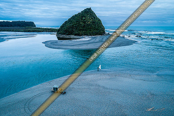 Photo of Lone whitebaiter scooping whitebait at the Wanganui River mouth at dawn on the rising tide. Mt Oneone headland beyond. Aerial view, Harihari, Westland, West Coast Region, New Zealand (NZ)