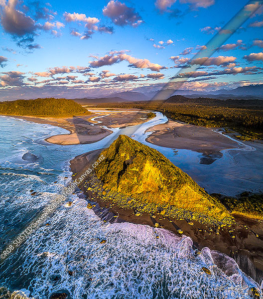 Photo of Wanganui River mouth and Wanganui Heads. Mt Oneone (56m) prominent in foreground. Southern Alps visible beyond. Moody evening light. Aerial view, Harihari, Westland, West Coast Region, New Zealand (NZ)