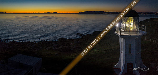 Photo of Baring Head lighthouse at twilight with last light over Cook Strait. Wellington City south coast visible at right. East Harbour Regional Park. Panorama, Baring Head, Hutt City, Wellington Region, New Zealand (NZ)